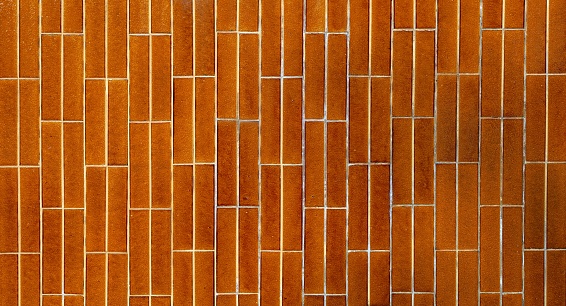 Vintage ceramic tiles, with long horizontal shape. Color is light brown. Background and texture, full frame.