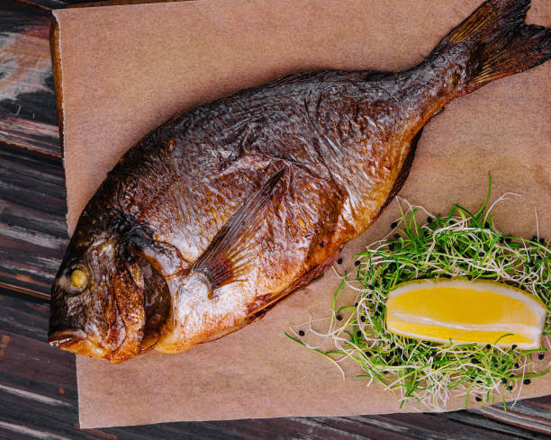 istock Board with fried dorado on wooden background 1987035749
