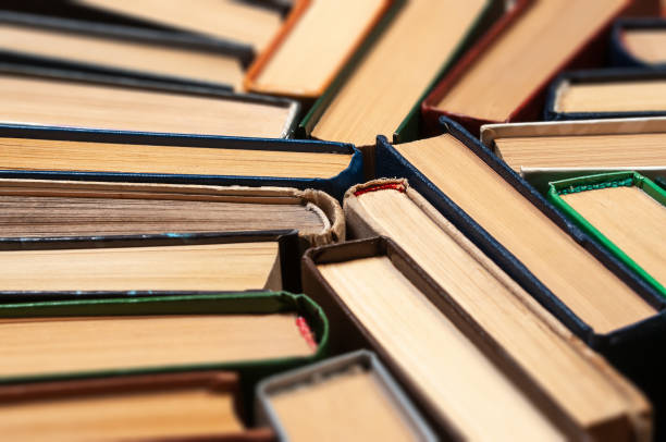 istock Many different hardcover old books on dark background, top view, selective focus 1987047911