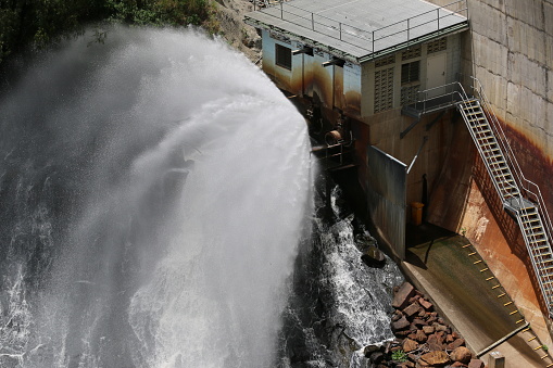 A regular controlled-release fountains out from a station set in the Moogerah Dam wall, providing water for farms and other areas downstream. Scenic Rim, South-East Queensland, Australia.