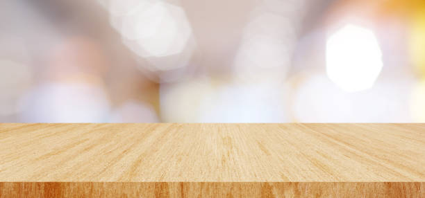 istock Wood table background and blur background, Empty wooden counter, shelf surface over blur restaurant with bokeh background, Wood table top for retail shop, store product display backdrop, banner, mock up, template 1987065343