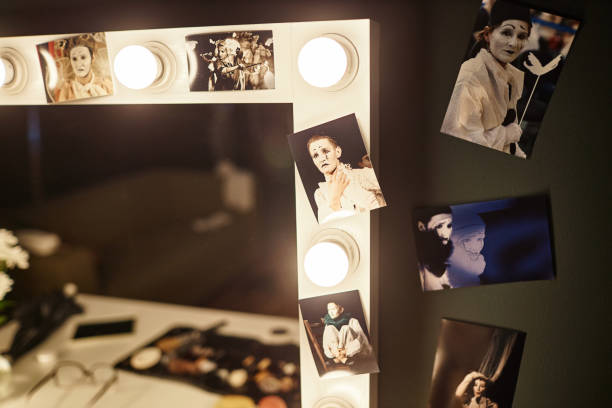 Vanity Table with Assorted Pictures on Mirror Close up of vanity table with assorted pictures of performer framing mirror, copy space theatre mirror stock pictures, royalty-free photos & images