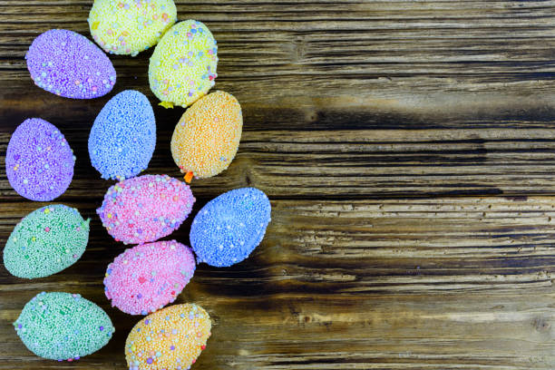 Easter eggs made of styrofoam on wooden background. Top view