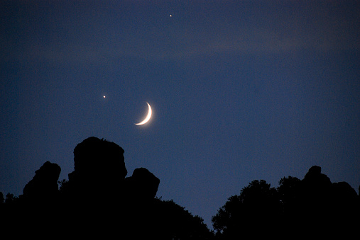 New Moon and a star Over forest