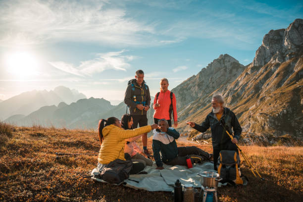 istock Diverse Friends Enjoying Hot Drinks After Hike 1987087396