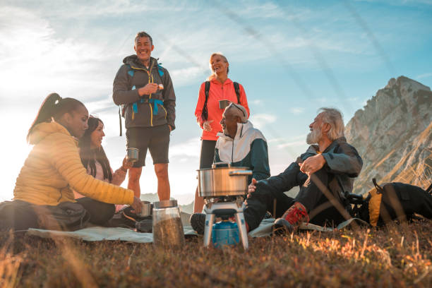 istock Diverse Friends Enjoying Hot Drinks After Hike 1987087422
