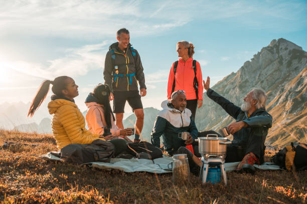istock Diverse Friends Relaxing with Tea on Mountain Top 1987087958