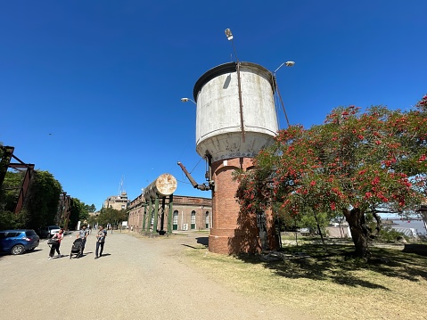 colonia del sacramento, uruguay - november 2 2022: a water tower with reservoir for steam trains on an abandoned retro railway station
