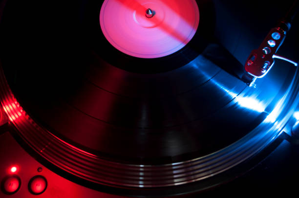istock Turntable Illuminated by Blue and Red Artificial Light that Plays a Disc 1987092506