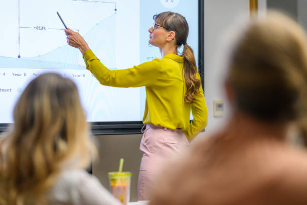 istock Young woman giving presentation. 1987095290