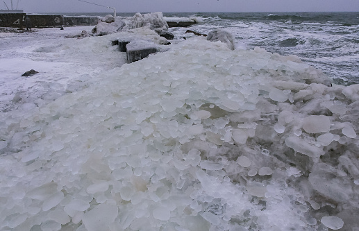 The Black Sea is frozen, the circular ice rolled by the waves is thrown ashore and frozen