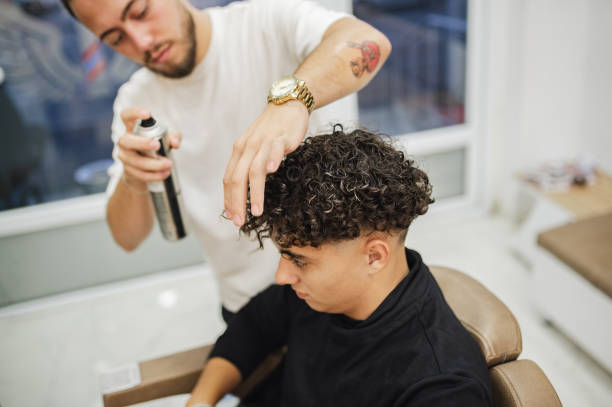 istock Barber Giving A Haircut in His Shop 1987103704