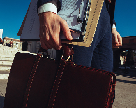 Business man portraits: leather suitcase and tools