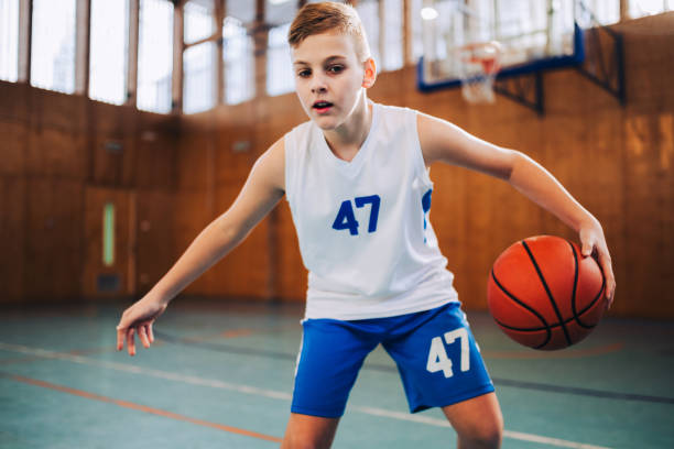istock A young basketball player in action dribbling a ball on training. 1987105502