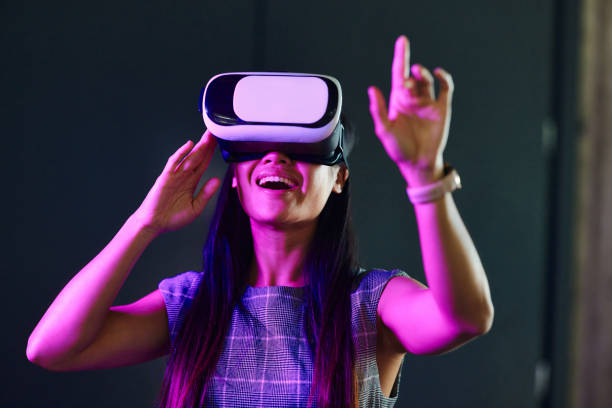 istock Happy businesswoman using VR headset in the office. 1987110776