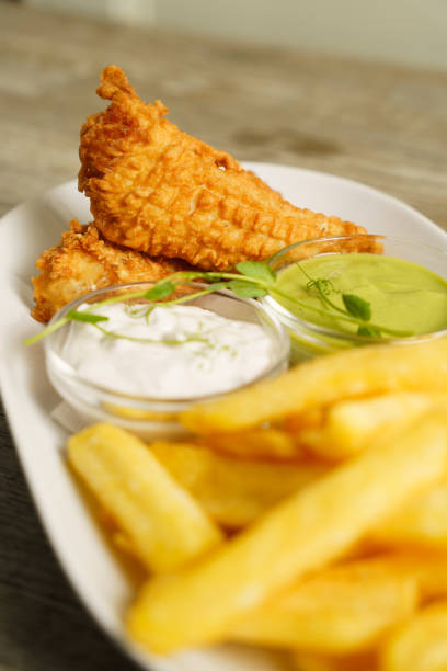 istock Fish and chips with tartare sauce on wooden table 1987121942