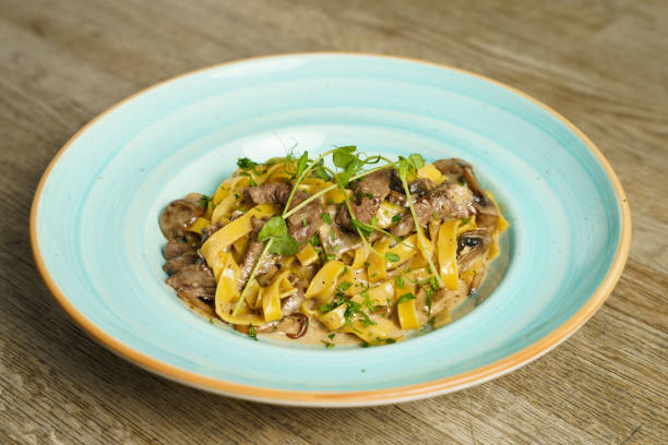 istock Pork with pasta and mushroom sauce 1987122463