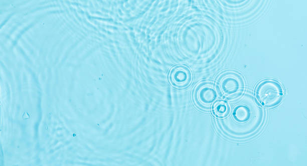 istock Abstract water, cosmetic background with rings, water surface. Spa concept. Splash cosmetic moisturizer water micellar toner or emulsion 1987146104
