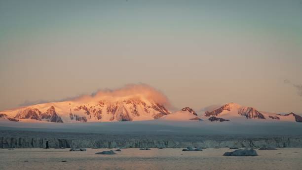 istock Antarctica Peninsula Colorful Sunrise Icebergs floating on Antarctic Ocean 1987152800