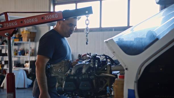 istock Aerospace industry. Aircraft mechanic repairs airplane engine. 1987155026