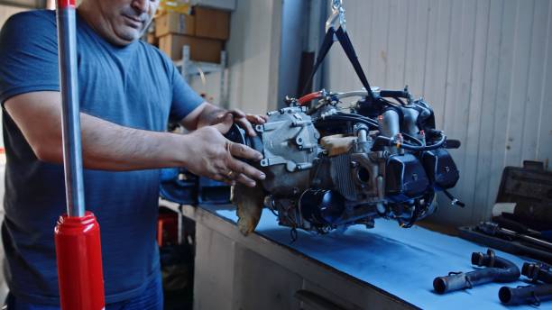 istock Aerospace industry. Aircraft mechanic repairs airplane engine. 1987155609