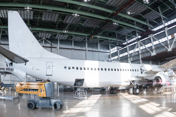 istock White passenger jetliner in the aviation hangar. Jet plane under maintenance 1987160504