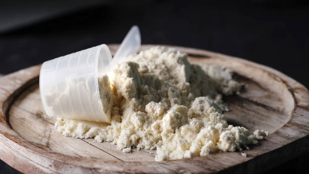 istock A rotating scoop of whey protein powder on a board. 1987165520