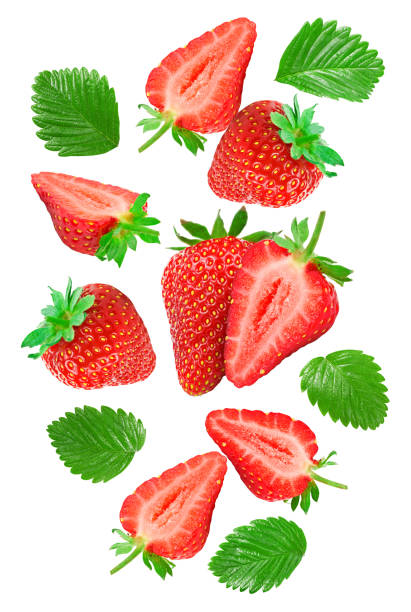 istock flying Sliced strawberry with green leaves isolated on white background. clipping path 1987182364