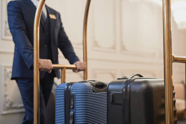 Man pushing cart with bags and luggage