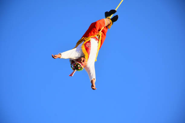 Leon, Mexico. Feb 3. Voladores de Papantla -Papantla Flyers- performing an antique 600 B.C. Totonaca ritual to Gods to get long life, wellness and prosperity, from El Tajin, Papantla, Veracruz, Mexico during Feria de Leon at Heritage Plaza on February 3, 2024 in Leon, Mexico.