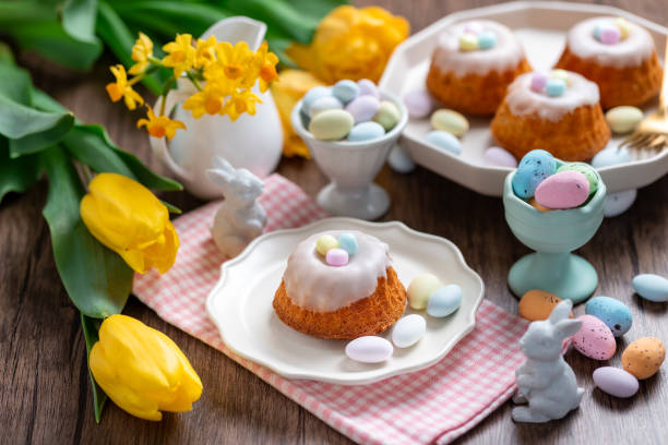 istock Homemade delicious mini lemon bundt cakes and chocolate eggs on a easter table with fresh spring flowers. 1987195992