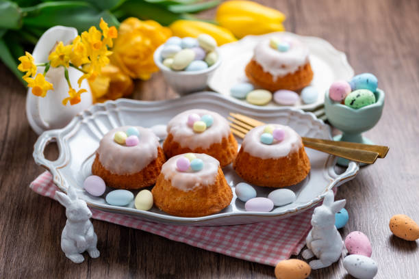 istock Homemade delicious mini lemon bundt cakes and chocolate eggs on a easter table with fresh spring flowers. 1987196499