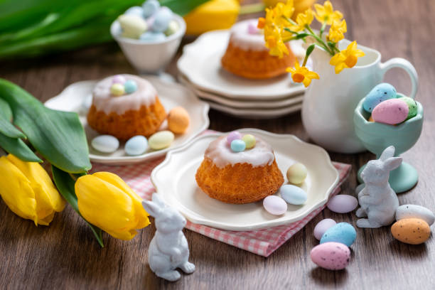 istock Homemade delicious mini lemon bundt cakes and chocolate eggs on a easter table with fresh spring flowers. 1987196506