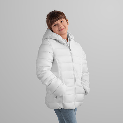 Girl in a chic white winter jacket - outerwear template for advertising. Elegant design for commercial use. Mockup of warm clothes on a child in jeans, place for printing and branding. Front view