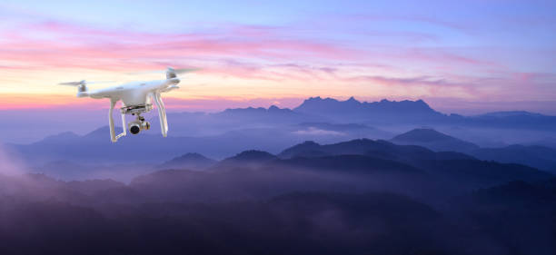 istock Drone surveys with digital camera Drone with high resolution digital camera Flying camera takes photos and videos Drone with professional camera takes photos of misty mountains. 1987219432