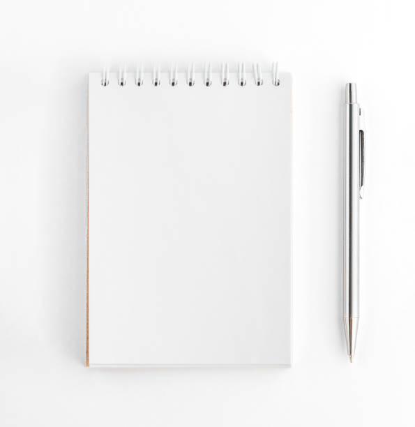 istock Spiral Notepad with Pen on white. White notebook and pen. 1987224712