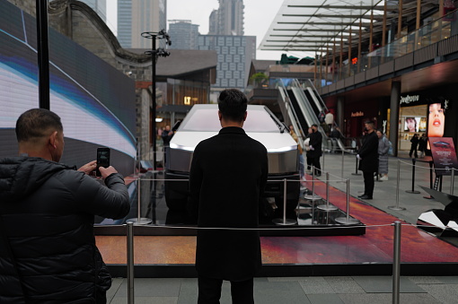 ChengDu China - February 5 2024: The Tesla Cybertruck exhibition at Taikoo Li Business Center in Chengdu attracts a crowd of onlookers, set against the backdrop of traditional Chinese architecture and modern office buildings, showcasing the beauty of the collision between tradition and modernity.Captured with the Leica Q3.Chengdu,China.