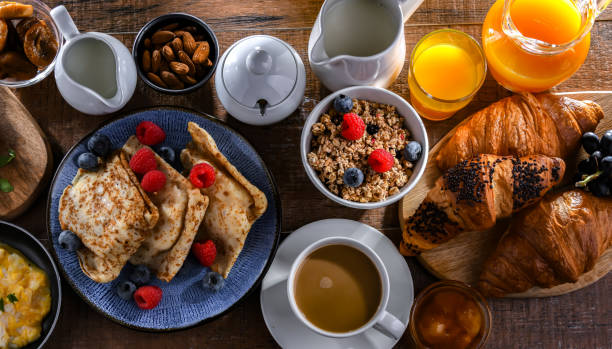 istock Breakfast served with coffee, eggs, cereals nd croissants 1987237076
