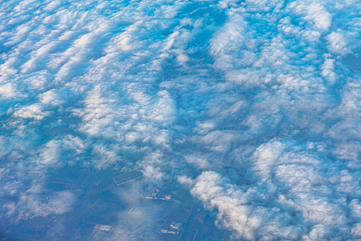 Aerial tranquil view of a blue sky is adorned with billowing clouds