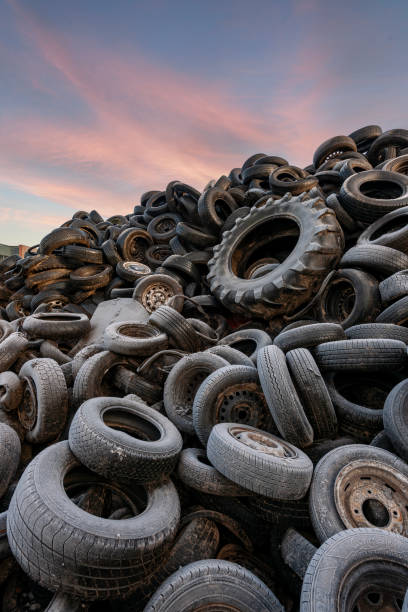 istock pile of used car tires at dawn. 1987263743