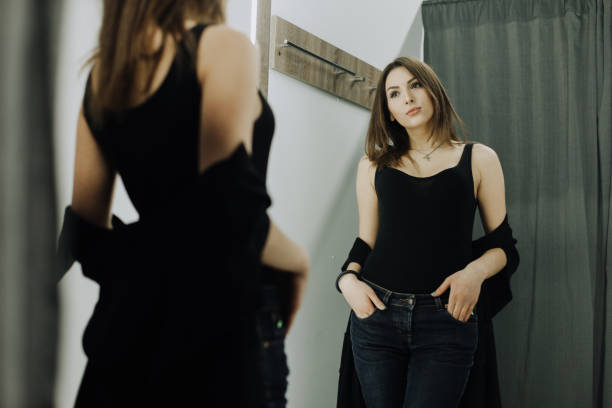 istock Woman with dress in the checkroom 1987265849