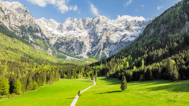 Zgornje Jezersko valley in Slovenia aerial view during a beautiful springtime day with the mountain range around the Grintovec mountain peak in the Kamnik–Savinja Alps.