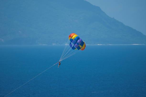 istock Single person paragliding at beau vallon beach 1987288205