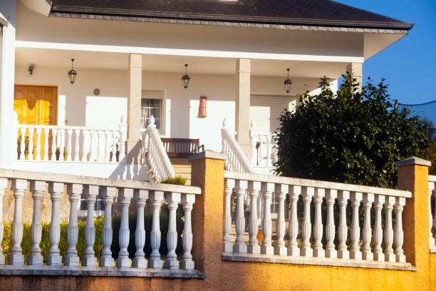 Detail of a white baluster, front door, porch and staircase. A Coruña province, Galicia, Spain.