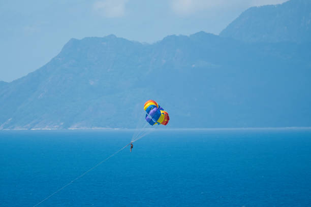 istock Single person parachuting at beau vallon beach 1987290899