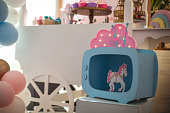 Little girl party decoration with sweet bar and pink unicorns