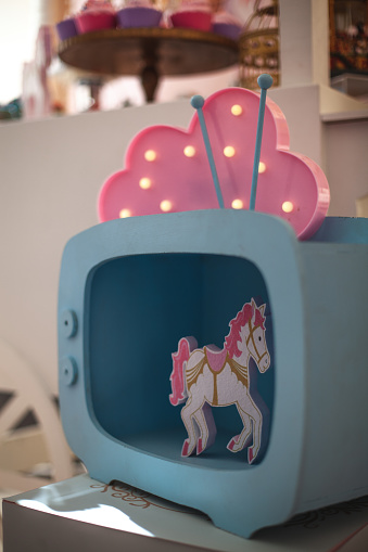 Little girl party decoration with sweet bar and pink unicorns