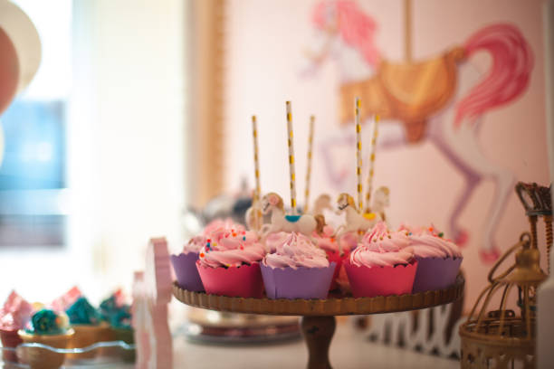 Party decoration for little girl's birthday, colorful cupcakes and unicorn