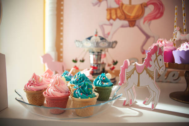 Party decoration for little girl's birthday, colorful cupcakes and unicorn