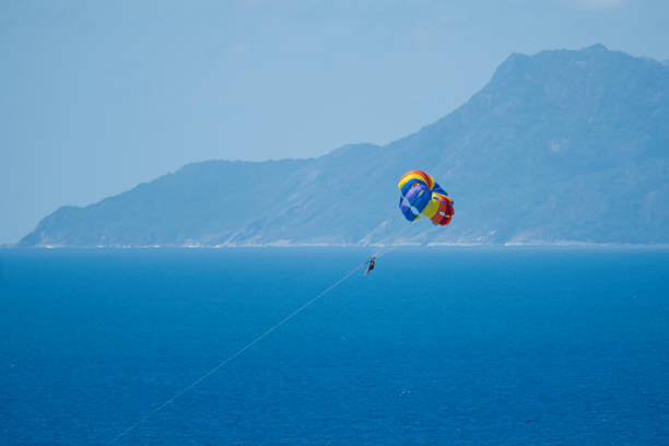 istock Single person parachuting at beau vallon beach 1987293718
